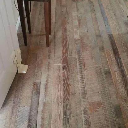 Closeup of reclaimed 120-year-old tobacco-pine floorboards, saw marks preserved — Brighton reclamation