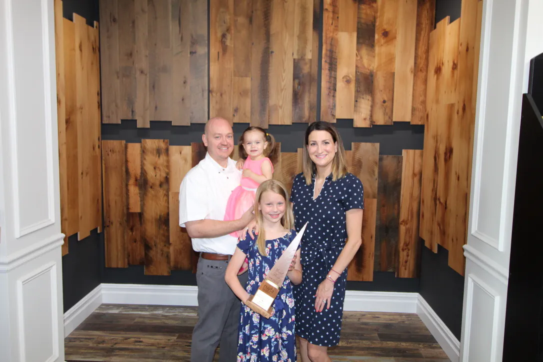 The Malaski family gathered in their flooring showroom